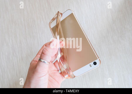 Silicone case for smartphone bent in his hand Stock Photo