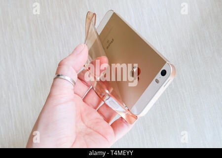 Silicone case for smartphone bent in his hand Stock Photo