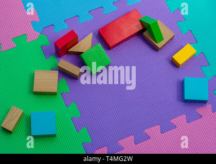 Children's wood play blocks on a colourful background Stock Photo
