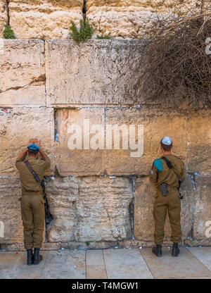 Jerusalem,Israel,29-march-2019:Israeli Soldiers Prays at Western Wall (Wailing Wall) in Jerusalem, Israel Prayers on paper scraps are stuffed between the stones Stock Photo