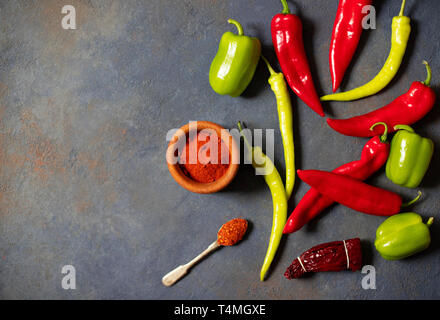 Peppers. Different kinds of pepper. Red peppers, green peppers, hot peppers, dried paprika, paprika powder, jalapeno, chili, spices. Top view. Stock Photo