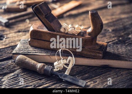 Old planer and other vintage carpenter tools in a carpentry workshop Stock Photo