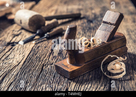 Old planer and other vintage carpenter tools in a carpentry workshop Stock Photo