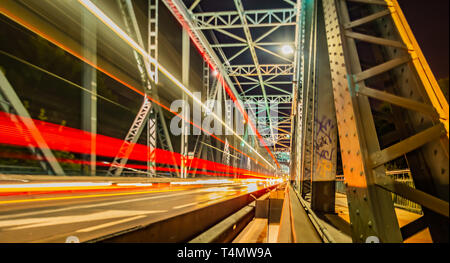 Car a streak of light on the Bridge at night Stock Photo