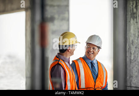 Two construction managers talking on building site. Stock Photo