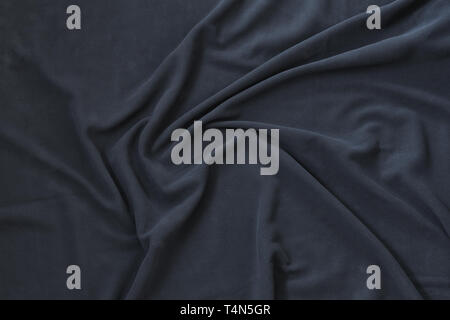 Wavy texture of dark blue fleece, soft napped insulating fabric made of polyester, top view background pattern Stock Photo