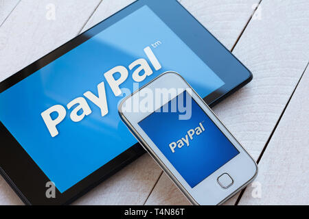 KIEV, UKRAINE - March 22: PayPal payment system logo on tablet and smarphone, in Kiev, Ukraine, on March 22, 2014. Stock Photo