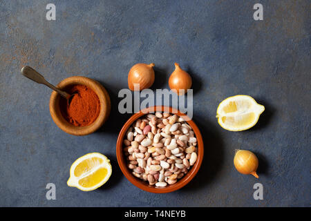 Prebranac ingredients. Balkan baked beans. Serbian, Montenegrin, Bosnian, Croatian and Slovenian cuisine. Uncooked beans, onion, lemon, paprika powder Stock Photo