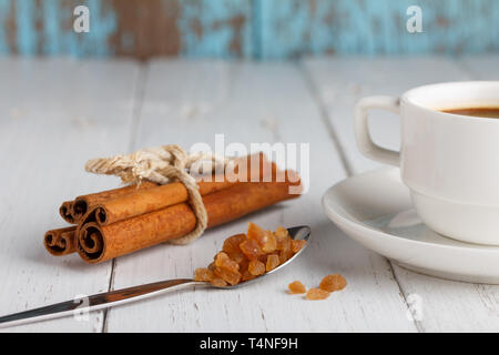 Coffee with caramel sugar and cinnamon on wooden table Stock Photo