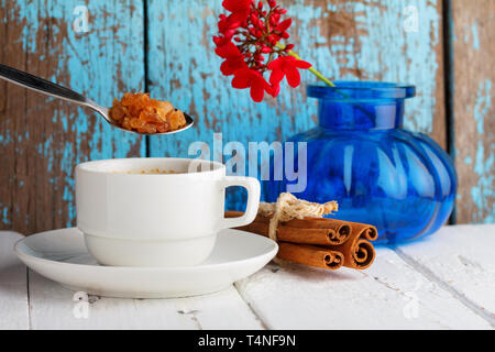 Coffee with caramel sugar and cinnamon on wooden table Stock Photo