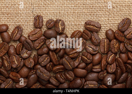 Coffee beans on sack background Stock Photo