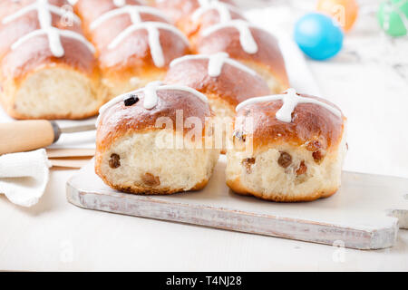 Freshly baked homemade hot cross buns on Easter table Stock Photo