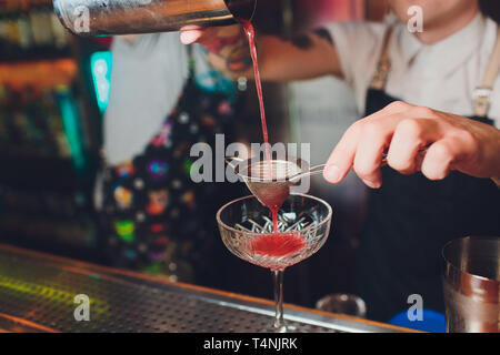 https://l450v.alamy.com/450v/t4njrk/bartender-making-refreshing-coctail-with-strawberries-isolated-on-a-bar-background-t4njrk.jpg