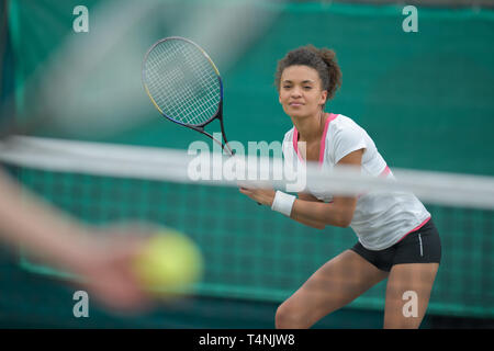 woman tennis player with racket during a match game isolated Stock Photo