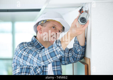 professional cctv technician installing camera Stock Photo