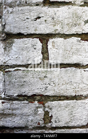 Pattern of a brick wall with peeling  white paint Stock Photo