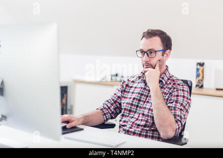Business professional working process at office. Sitting at the desk and working on computer. Stock Photo
