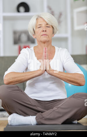 senior woman in yoga lotus position for meditation and relaxation Stock Photo
