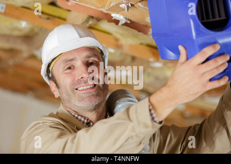 man installing thermal roof insulation layer Stock Photo