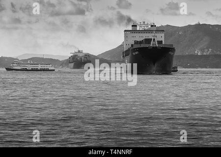 Black And White Photo Of The Evergreen Container Ship, EVER DAINTY, In The East Lamma Channel, Heading To The Kwai Tsing Container Terminal, Hong Kong Stock Photo