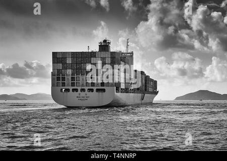 Moody Black and White Photo Of A WAN HAI LINES Container Ship, WAN HAI 501, Entering The East Lamma Channel As She Leaves Victoria Harbour, Hong Kong Stock Photo