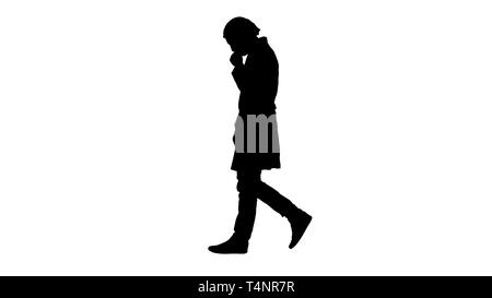 Full length portrait side view. Silhouette Thoughtful male doctor walking. Professional shot in 4K resolution. 004. You can use it e.g. in your commer Stock Photo