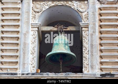 Isolated Green Bronze Bell on Tower of Spanish Catholic Church in Old City Antigua Guatemala Stock Photo