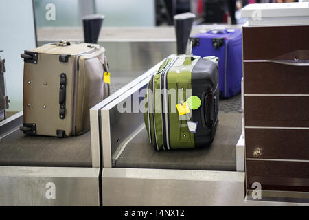 Luggage on weight at check-in counter at airport Stock Photo
