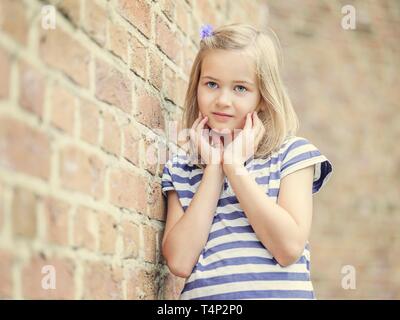 Girl, 10 years, leaning against a wall, Portrait, Germany Stock Photo