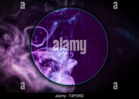 Close-up pink and blue cloud of smoke   blown under a magnifying glass on  black isolated background. Background from the smoke of vape Stock Photo