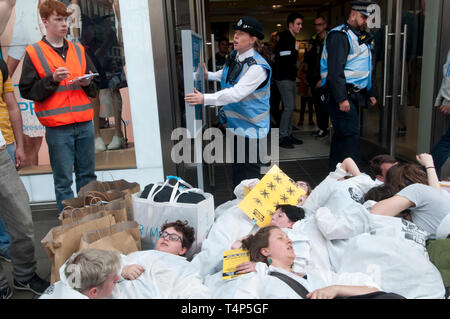 Extinction Rebellion protest, London September 17th 2019. Oxford Circus. Young people stage die-in wearing haz chem suits in front of shops to draw at Stock Photo