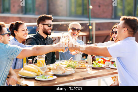leisure and people concept - happy friends toasting non alcoholic drinks at rooftop party in summer Stock Photo