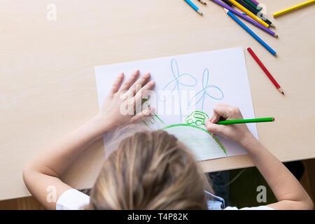 https://l450v.alamy.com/450v/t4p82k/a-girl-draws-with-pencils-a-green-house-planet-car-wind-power-plants-concept-of-ecology-and-environmental-protection-t4p82k.jpg