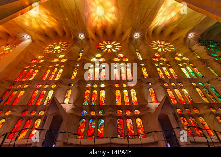 Light through the colorful stained glass window of Sagrada Familia (Church of the Holy Family), the cathedral designed by Gaudi in Barcelona, Spain Stock Photo