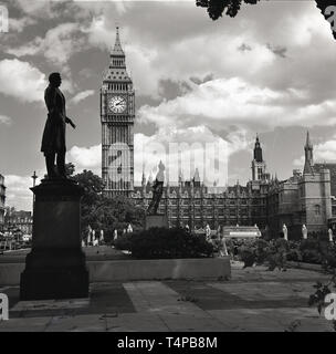1960s, historical, View of the Elizabeth or Clock Tower ( Big Ben) and the Palace of Westminster, home of the UK Parliament seen from across Parliament Square, where twelve statues reside. On the left seen here is the statue dedicated to Henry John Temple, 3rd Viscount Palmerston, twice a British Prime Minister. Stock Photo