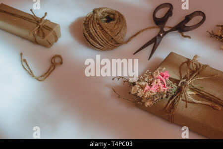 Beautiful small handmade DIY gift box (package) with flowers and decorative  rope on brown background. Vintage Retro Style. Flat lay Top view with copy  Stock Photo - Alamy