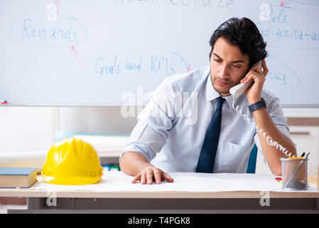 Young male architect in front of the whiteboard Stock Photo
