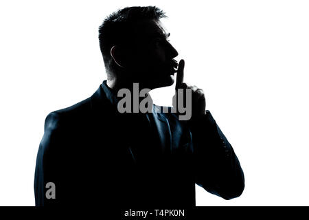 one caucasian man hushing profile portrait silhouette in studio isolated white background Stock Photo