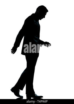 one caucasian business man walking silhouette Full length in studio isolated on white background Stock Photo