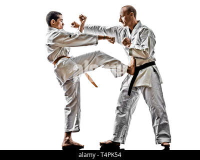 two karate men sensei and teenager student fighters fighting isolated on white background Stock Photo