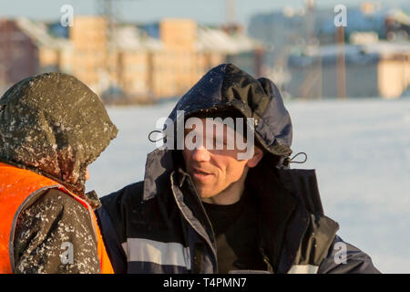Installers are in a good mood at the construction site talking Stock Photo