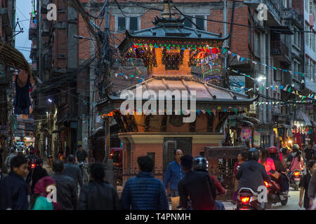 A busy street with a buddhist temple in downtown Kathmandu, Nepal,  on a late afternoon. Stock Photo