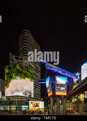 The neon lights and bright LED signs of Yonge-Dundas Square (Dundas Square) and the Eaton Centre at night in downtown Toronto, Ontario, Canada Stock Photo