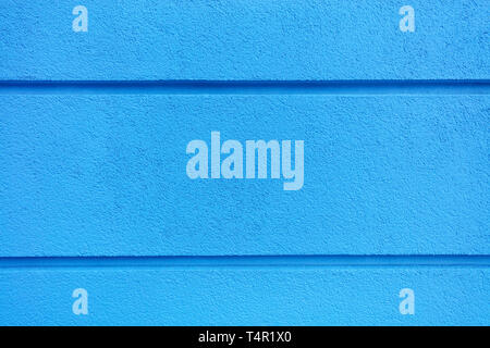 Concrete wall texture with colored bright blueplaster. Construction coat-plaster made of insulated material on the wall with horizontal dividing groov Stock Photo