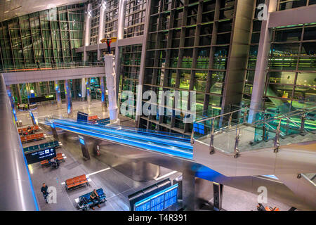 Doha, Qatar - February 24, 2019: aerial view of interior lobby and escalator of Hamad International Airport or Doha Hamad Airport, the only airport in Stock Photo