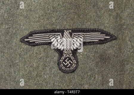 A field tunic M 43 ('two-hole jacket') for an SS member of the 23rd SS Volunteer Panzer Grenadier Division 'Nederland' (Dutch no. 1) Field-grey felt, field-grey painted buttons, machine-stitched sleeve eagle (BeVo issue), the sleeve insignia and collar patches (RZM-embroidered) likewise machine-stitched. Grey inner liner with depot and size stampings. Very rare. historic, historical, 20th century, 1930s, 1940s, Waffen-SS, armed division of the SS, armed service, armed services, NS, National Socialism, Nazism, Third Reich, German Reich, Germany, military, militaria, utensil,, Editorial-Use-Only Stock Photo