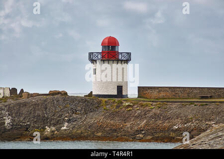 Burry Port Lighthouse on a windy Summers day, situated on the small Breakwater of the harbour, once used for shipping coal. Burry Port, Wales. Stock Photo