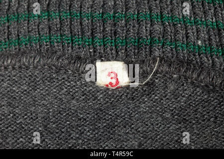 A pullover, officially 'Schlupfjacke 36' for army personnel Issue with rounded neckline in grey wool, the collar with four woven-in green bands, sewn-in size tag '3'. historic, historical, 20th century, Editorial-Use-Only Stock Photo
