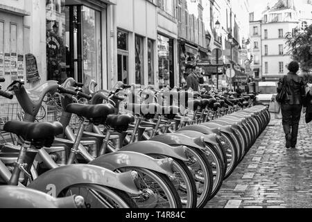 Rental bikes in a row on a street in Paris, France