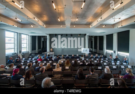 18 April 2019, Saxony-Anhalt, Dessau-Roßlau: Participants of a festive event sit in the assembly hall of the Bauhaus in Dessau. After extensive renovation work, the original Bauhaus buildings open before Easter. For the anniversary year 2019 they will receive a new coherent curatorial narrative. The buildings themselves become exhibition objects. Photo: Hendrik Schmidt/dpa-Zentralbild/ZB Stock Photo